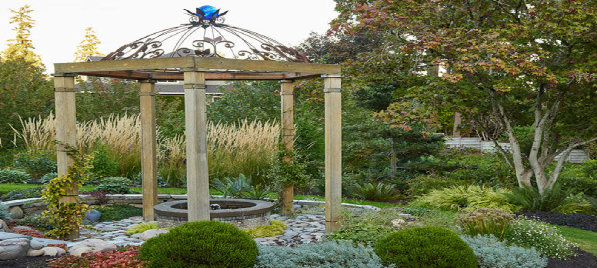 Garden scene with a wooden gazebo surrounded by plants and trees